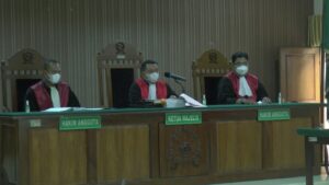 Majelis hakim yang menyidangkan kasus pembunuhan 1 keluarga. (Foto atas) Terdakwa Sumani (pojok atas pakai rompi) menjalani sidang perdana secara online, Rabu (02/06).