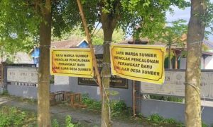 Banner yang dipasang warga, memprotes pengisian perangkat desa Sumber, Kecamatan Sumber.