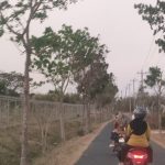 Warga melintas di jalan raya yang berdekatan dengan area pemakaman keluarga PT. Djarum, turut tanah Desa Punjulharjo Rembang.